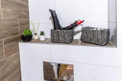 a white counter with two baskets and some plants at Apartman Kolarević in Arandjelovac