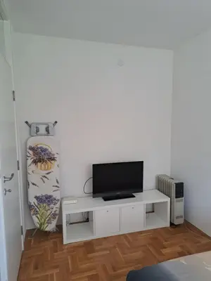 a living room with a tv on a white cabinet at Belgrade Stepa Stay in Belgrade