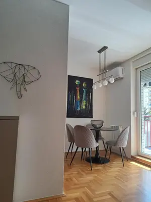 a living room with a dining room table and chairs at Belgrade Stepa Stay in Belgrade