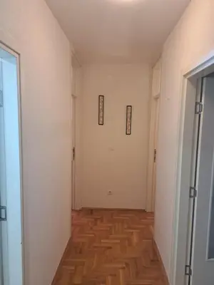 an empty hallway with white walls and wood floors at Belgrade Stepa Stay in Belgrade
