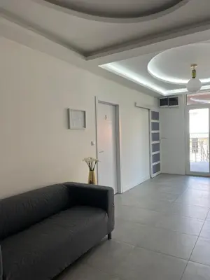 a living room with a couch and a ceiling at BeoAir apartments in Surčin