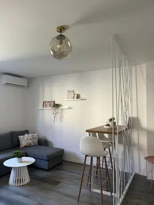 a living room with a couch and a table at BeoAir apartments in Surčin