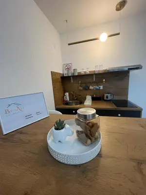 a table with a plate of food on top of it at BeoAir apartments in Surčin