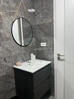 a bathroom with a sink and a mirror at BeoAir apartments in Surčin