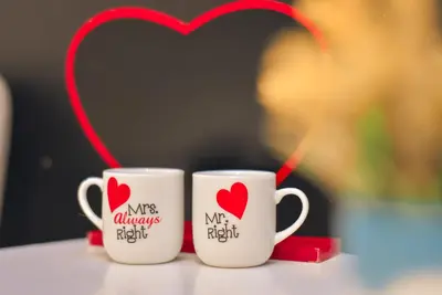 two coffee mugs with hearts on them on a table at Hedonist Spa-ABlok 1 in Belgrade
