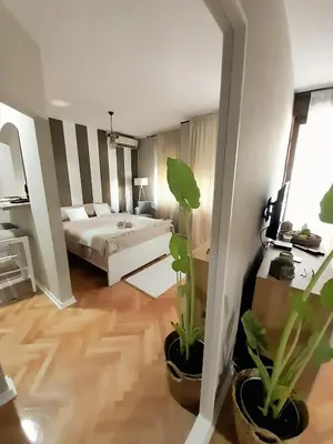 a bedroom with a bed and two potted plants at HARMONY in Žarkovo
