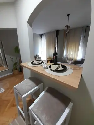 a kitchen with a table with a wine bottle and glasses at HARMONY in Žarkovo