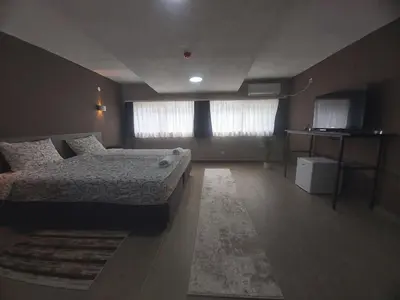 a large bedroom with a bed and a window at Vila Kruna in Belgrade
