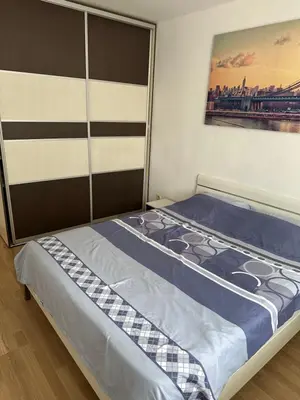 a bed in a room with a picture on the wall at Apartman BK LUX in Belgrade