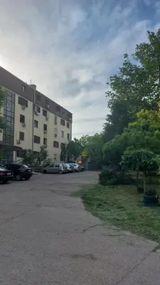 a parking lot with cars parked in front of a building at Plavi Tirkiz in Pančevo