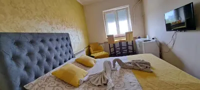 a bedroom with a bed with a couch and a television at Sajam in Senjak (historical)