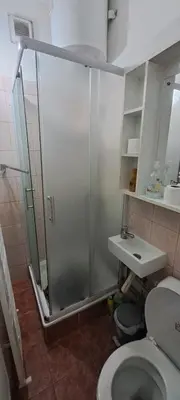 a bathroom with a shower with a toilet and a sink at Sajam in Senjak (historical)