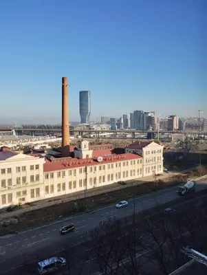 a large white building with a factory in the city at Sajam in Senjak (historical)