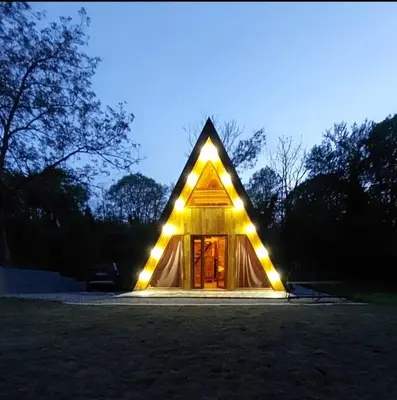 a small house with lights on the front of it at Luna kuća- Devojački bunar in Novi Vladimirovac