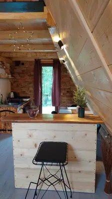 a black chair sitting at a bar in a cabin at Luna kuća- Devojački bunar in Novi Vladimirovac
