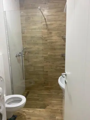 a bathroom with a toilet and a glass shower at Apartman Fame near Airport in Surčin