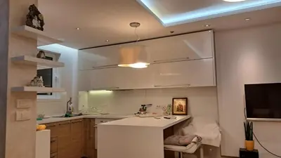 a kitchen with a white counter and a sink at Lux Apartman 7 in Voždovac