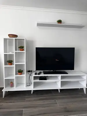 a white entertainment center with a flat screen tv at MELIORA Apartment in Belgrade