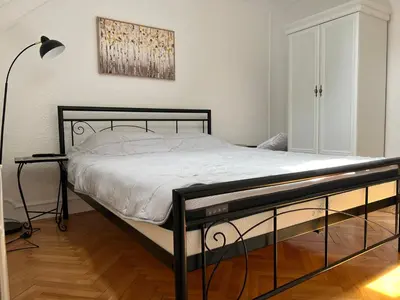 a bedroom with a bed with a black frame at Plavi Dunav in Stari Slankamen