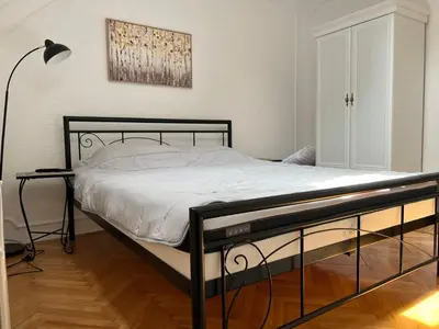 a bedroom with a bed with a black frame at Plavi Dunav in Stari Slankamen