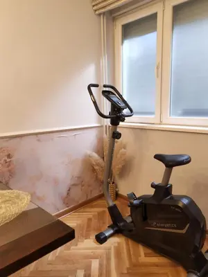 a exercise bike in a room with a wall at AirCity Apartment in Belgrade