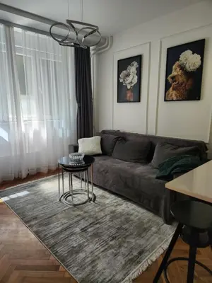 a living room with a couch and a table at AirCity Apartment in Belgrade