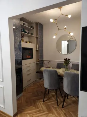 a dining room with a table and chairs and a mirror at AirCity Apartment in Belgrade