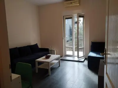a living room with a couch and a table at Flower Square Studio in Belgrade