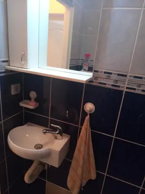 a small bathroom with a sink and a mirror at Flower Square Studio in Belgrade