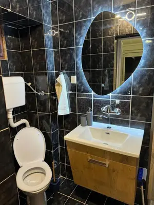 a bathroom with a toilet and a sink and a mirror at 89 rooms in Belgrade