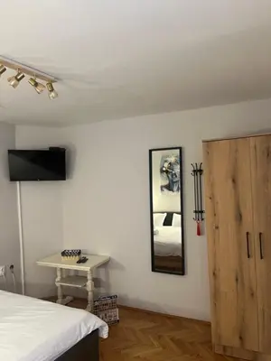 a bedroom with a bed and a table and a mirror at 89 rooms in Belgrade