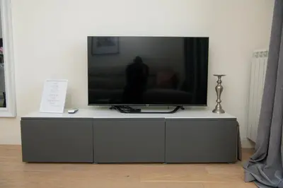 a flat screen tv sitting on top of a cabinet at Belgrade Waterfront Promenade in Belgrade