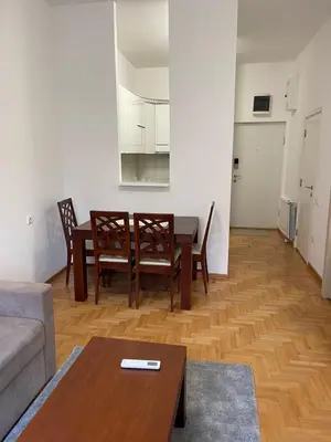 a living room with a table and chairs and a couch at Neds Apt Inc in Belgrade