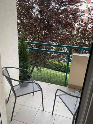 a balcony with two chairs and a fence at Neds Apt Inc in Belgrade
