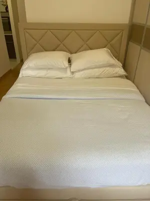 a large white bed with two pillows on it at Neds Apt Inc in Belgrade