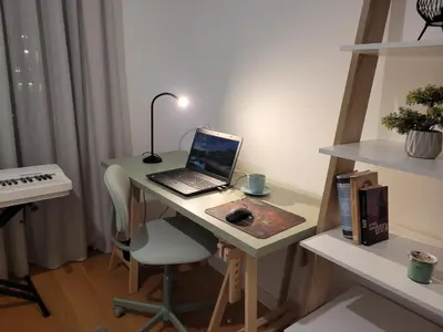 a laptop computer sitting on a desk with a keyboard at Kalemegdan Riverfront Apartment - K-District in Belgrade