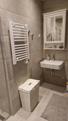 a bathroom with a shower and a sink and a mirror at Kalemegdan Riverfront Apartment - K-District in Belgrade