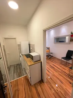 a room with a kitchen with a counter and a microwave at Welcome To Our Easygoing Apartment in Belgrade