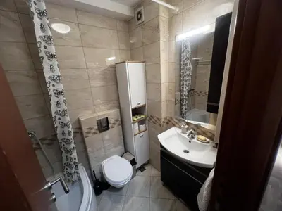 a bathroom with a toilet and a sink and a shower at Family Rakic Apartment in Belgrade
