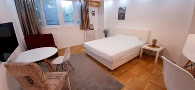 a small room with a bed and a table and chairs at Apartman Durmitor in Fontana