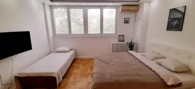 a living room with two beds and a tv at Apartman Durmitor in Fontana