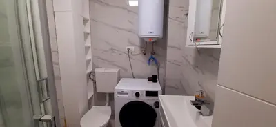 a small bathroom with a toilet and a sink at Apartman Durmitor in Fontana
