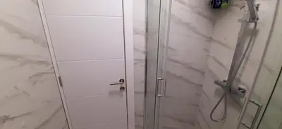 a shower with a glass door in a bathroom at Apartman Durmitor in Fontana