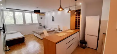 a kitchen with a desk and a couch in a room at Apartman Durmitor in Fontana