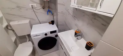 a small bathroom with a toilet and a sink at Apartman Durmitor in Fontana