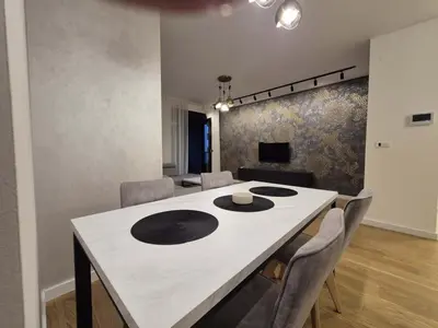 a dining room with a white table and chairs at Park Vila New Luxury apartments with garage in Belgrade