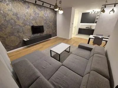 a living room with a couch and a table at Park Vila New Luxury apartments with garage in Belgrade
