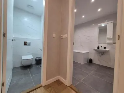 a bathroom with a toilet and a sink at Park Vila New Luxury apartments with garage in Belgrade