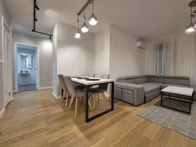 a living room with a table and a couch at Park Vila New Luxury apartments with garage in Belgrade