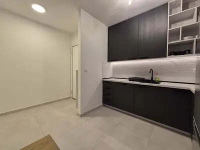 a kitchen with black cabinets and a white counter top at Park Vila New Luxury apartments with garage in Belgrade